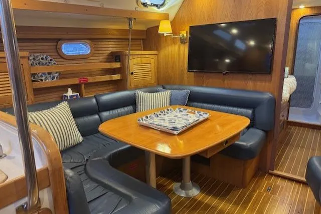 Slide: The Image of Luxurious interior of a 1999 Catalina 470 yacht with cozy seating and modern amenities. - 61
