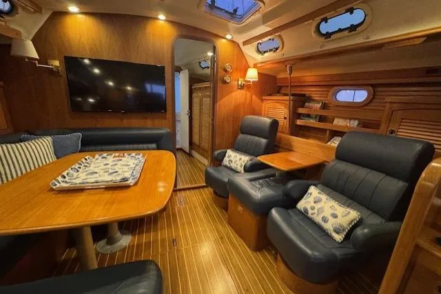 Slide: The Image of Luxurious interior of a 1999 Catalina 470 yacht with wood finish and comfortable seating. - 68
