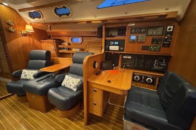 Slide: The Image of Luxurious interior of a 1999 Catalina 470 yacht with plush seating and navigation controls. - 74