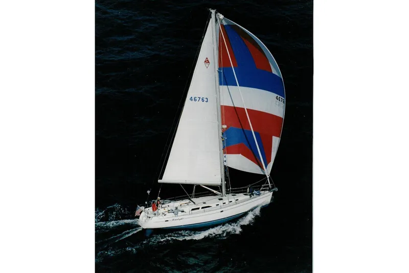 Slide: The Image of Sailing yacht Catalina 470 (1999) with colorful spinnaker on open water. - 77