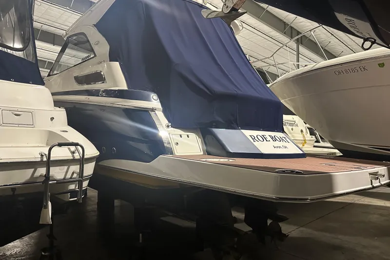 Slide: The Image of 2014 Regal 35 Sport Coupe in storage, covered, with adjacent boats. - 16