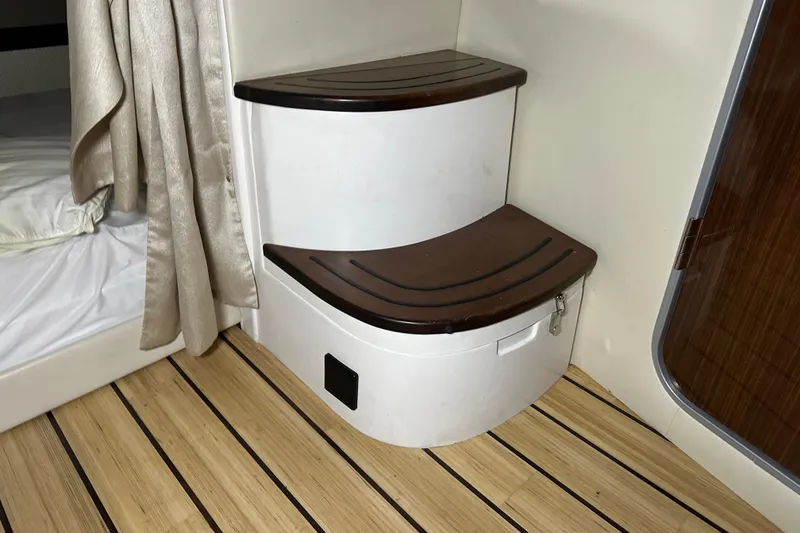 Slide: The Image of Interior of 2014 Regal 35 Sport Coupe with wooden steps and bed. - 21