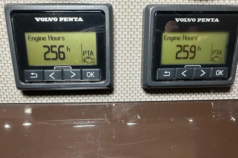 Slide: The Image of Engine hour meters showing 256 and 259. - 43