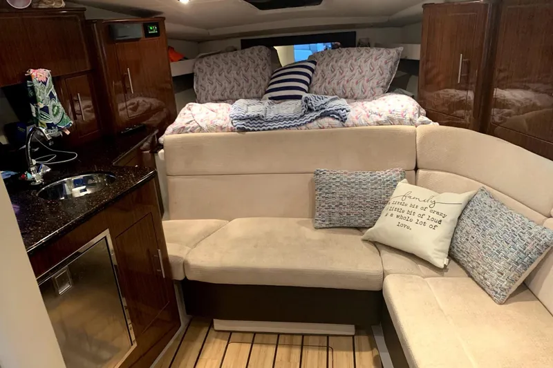 Slide: The Image of Interior of 2014 Regal 35 Sport Coupe with cozy seating and kitchenette. - 7