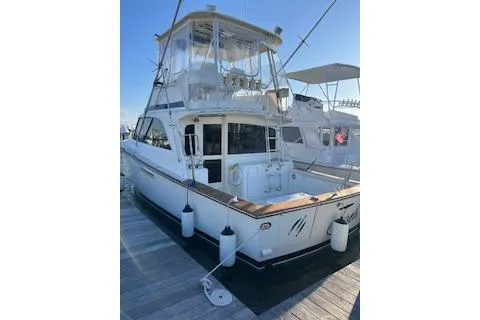 Slide: The Image of 1985 Ocean Yachts 38 Super Sport docked, showcasing sleek design and fishing equipment. - 1