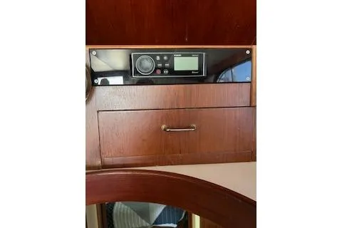 Slide: The Image of 1985 Ocean Yachts 38 Super Sport interior with wooden cabinetry and electronic control panel. - 11