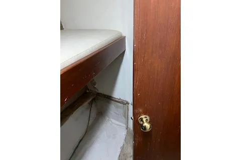 Slide: The Image of 1985 Ocean Yachts 38 Super Sport interior with wooden door and bunk bed. - 14