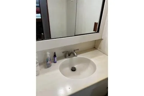Slide: The Image of 1985 Ocean Yachts 38 Super Sport bathroom sink with mirror and toiletries. - 18