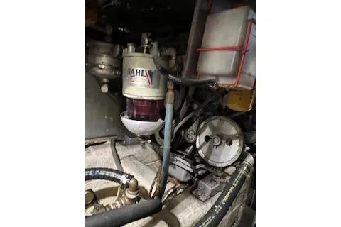 Slide: The Image of Engine compartment of a 1985 Ocean Yachts 38 Super Sport, showcasing mechanical components. - 25