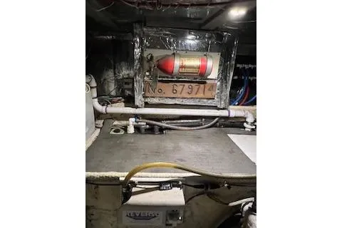 Slide: The Image of Engine room of 1985 Ocean Yachts 38 Super Sport with fire extinguisher and equipment. - 26
