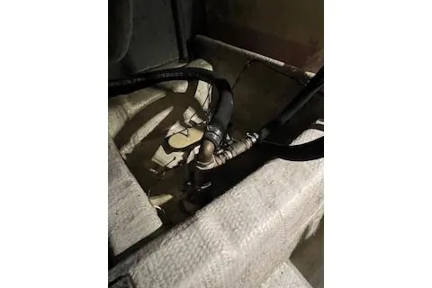 Slide: The Image of 1985 Ocean Yachts 38 Super Sport engine compartment with hoses and fittings. - 28