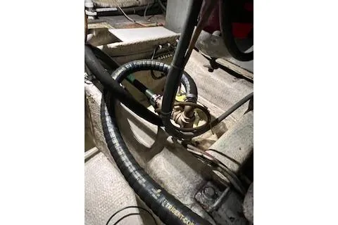 Slide: The Image of Engine room of 1985 Ocean Yachts 38 Super Sport with visible hoses and components. - 29