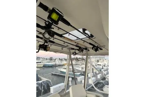 Slide: The Image of 1985 Ocean Yachts 38 Super Sport interior with fishing rods, docked at marina. - 7