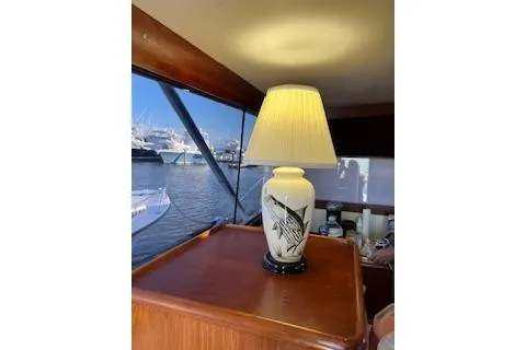 Slide: The Image of 1985 Ocean Yachts 38 Super Sport interior with decorative lamp and marina view. - 12