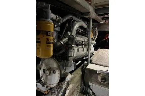 Slide: The Image of Engine room of 1985 Ocean Yachts 38 Super Sport, showcasing mechanical components. - 19
