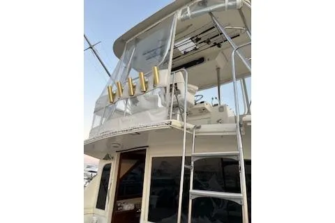 Slide: The Image of 1985 Ocean Yachts 38 Super Sport with flybridge and ladder, docked at marina. - 4