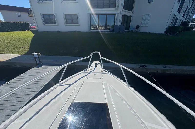 Slide: The Image of Bow view of a 2012 Intrepid 390 Sport Yacht docked near a residential building. - 10