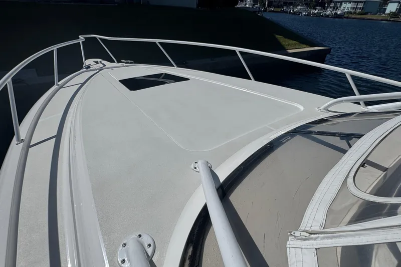 Slide: The Image of 2012 Intrepid 390 Sport Yacht bow view with railing and hatch. - 12
