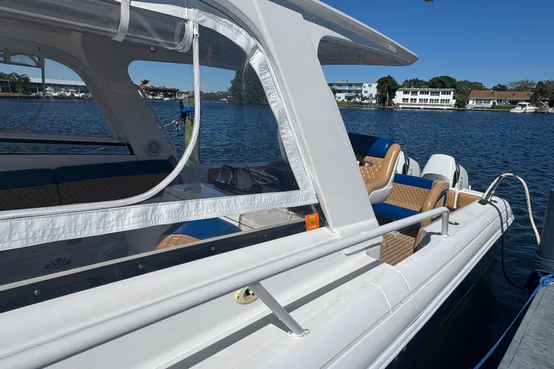 Slide: The Image of 2012 Intrepid 390 Sport Yacht docked on a sunny day, showcasing sleek design. - 14