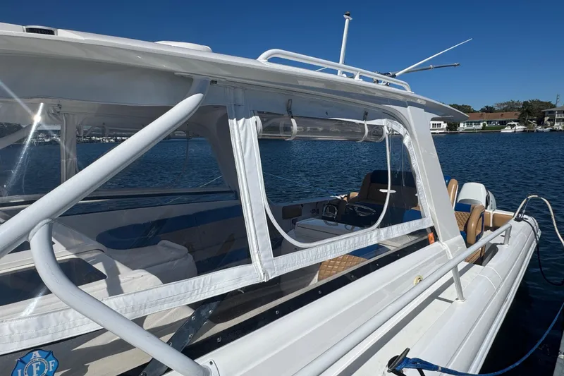 Slide: The Image of 2012 Intrepid 390 Sport Yacht docked on a sunny day, showcasing sleek design and spacious interior. - 16