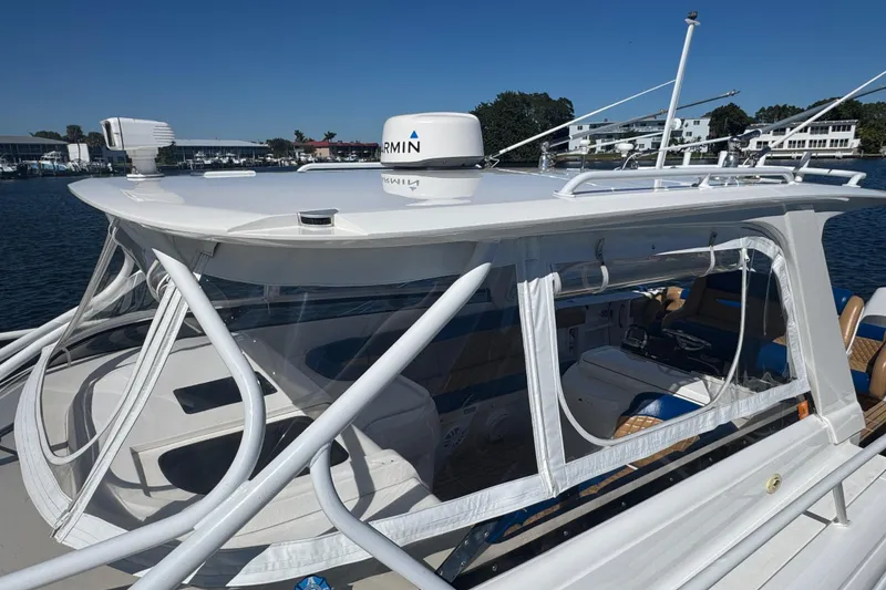 Slide: The Image of 2012 Intrepid 390 Sport Yacht with Garmin equipment, docked in a marina under clear blue skies. - 17