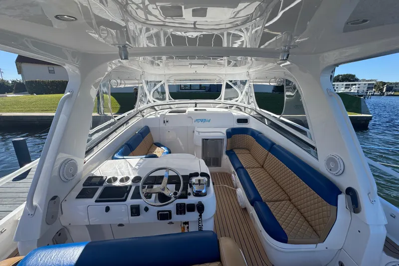 Slide: The Image of 2012 Intrepid 390 Sport Yacht interior with luxurious seating and modern helm. - 19