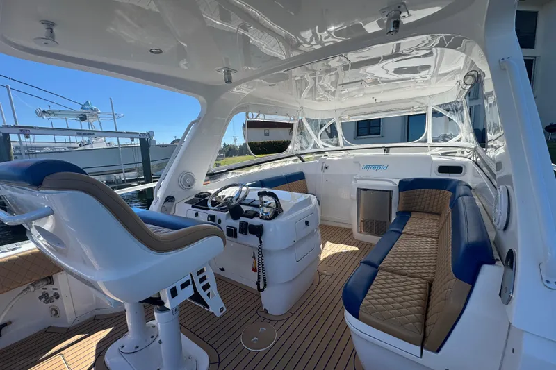 Slide: The Image of 2012 Intrepid 390 Sport Yacht interior with helm, seating, and modern design. - 20