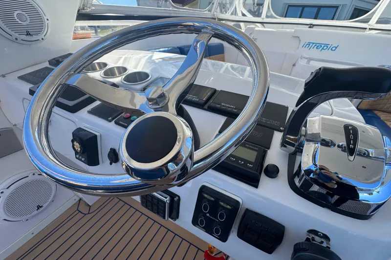 Slide: The Image of Steering wheel and controls of a 2012 Intrepid 390 Sport Yacht cockpit. - 26