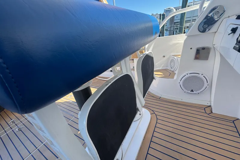 Slide: The Image of 2012 Intrepid 390 Sport Yacht interior with blue seating and teak flooring. - 29