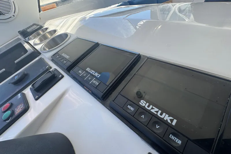 Slide: The Image of Control panel of a 2012 Intrepid 390 Sport Yacht with Suzuki displays. - 31