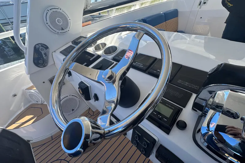 Slide: The Image of Steering wheel and controls of a 2012 Intrepid 390 Sport Yacht. - 32