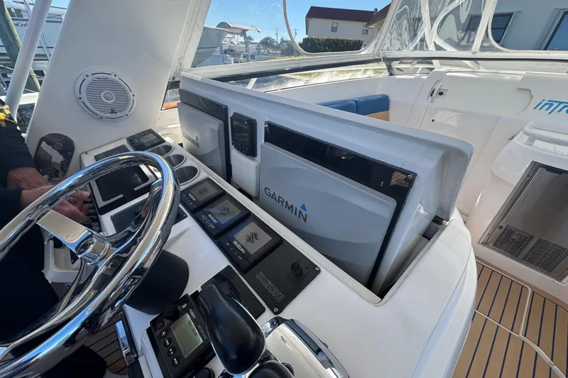 Slide: The Image of Intrepid 390 Sport Yacht 2012 helm with Garmin navigation and Suzuki controls. - 36