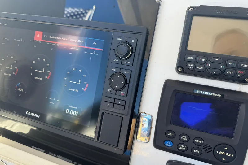 Slide: The Image of Control panel of a 2012 Intrepid 390 Sport Yacht with Garmin and Furuno displays. - 38