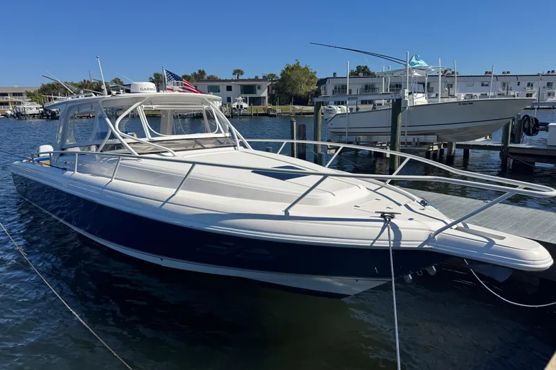 Slide: The Image of 2012 Intrepid 390 Sport Yacht docked in a marina, clear blue sky background. - 4