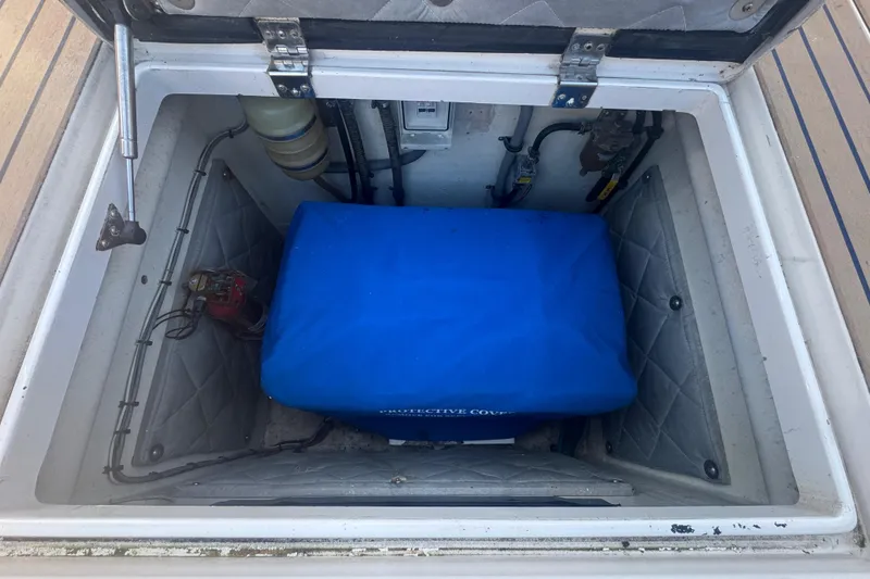 Slide: The Image of Open hatch of 2012 Intrepid 390 Sport Yacht showing engine compartment with blue cover. - 47