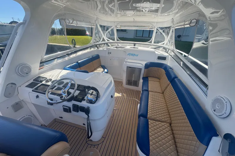 Slide: The Image of Luxurious 2012 Intrepid 390 Sport Yacht interior with plush seating and modern helm. - 48