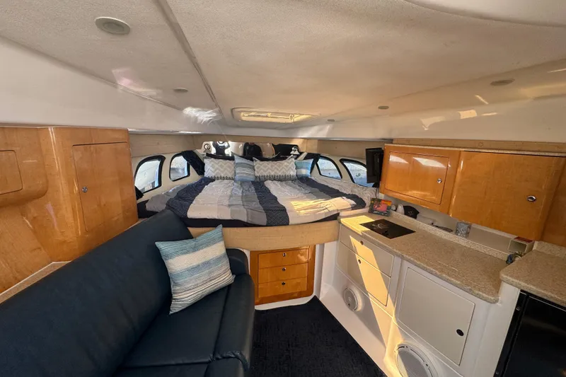 Slide: The Image of Interior of 2012 Intrepid 390 Sport Yacht with bed, sofa, and kitchenette. - 53