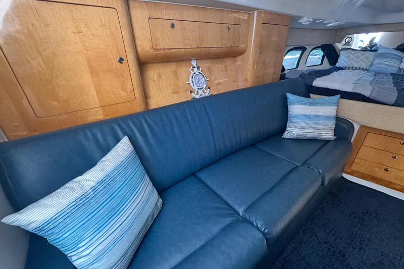 Slide: The Image of Luxurious interior of 2012 Intrepid 390 Sport Yacht with blue sofa and wooden cabinetry. - 54