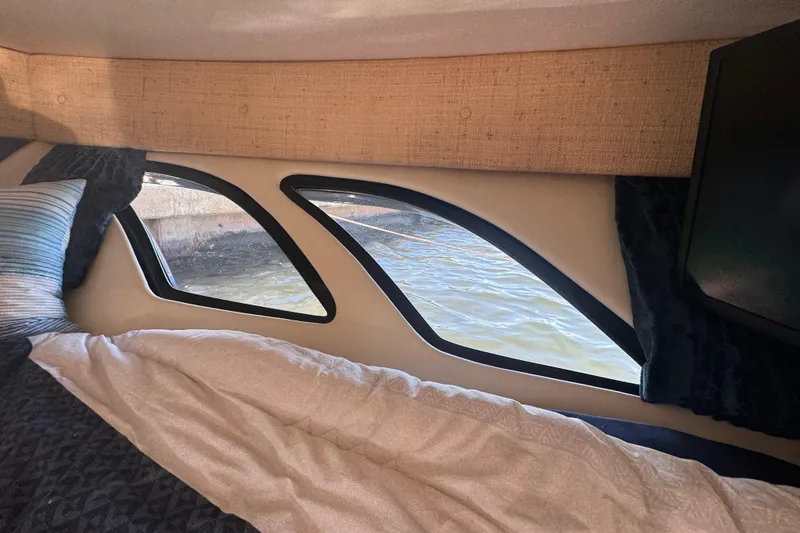 Slide: The Image of Interior cabin view of a 2012 Intrepid 390 Sport Yacht with water visible through windows. - 57