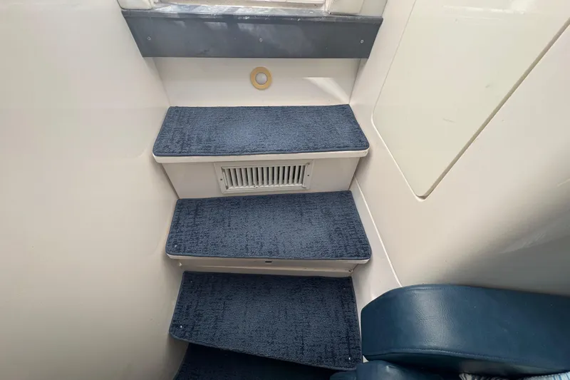 Slide: The Image of Interior steps of a 2012 Intrepid 390 Sport Yacht with blue carpet. - 63