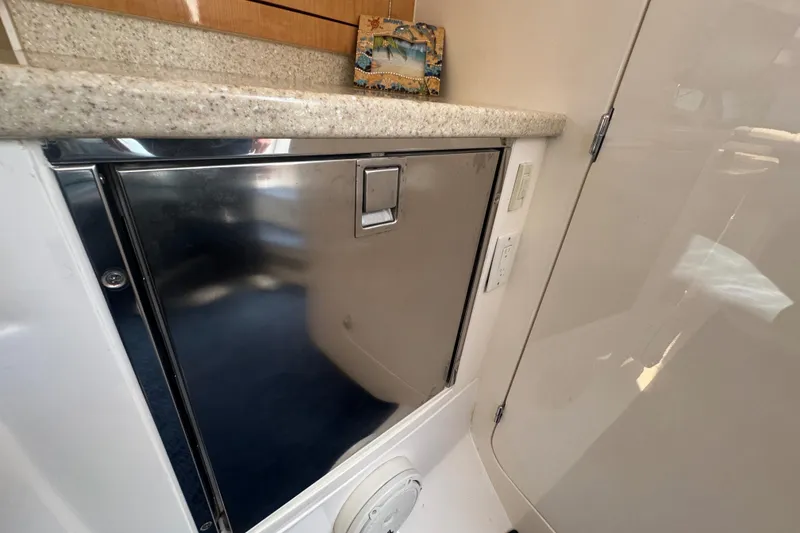 Slide: The Image of Interior of a 2012 Intrepid 390 Sport Yacht with stainless steel cabinet and countertop. - 66