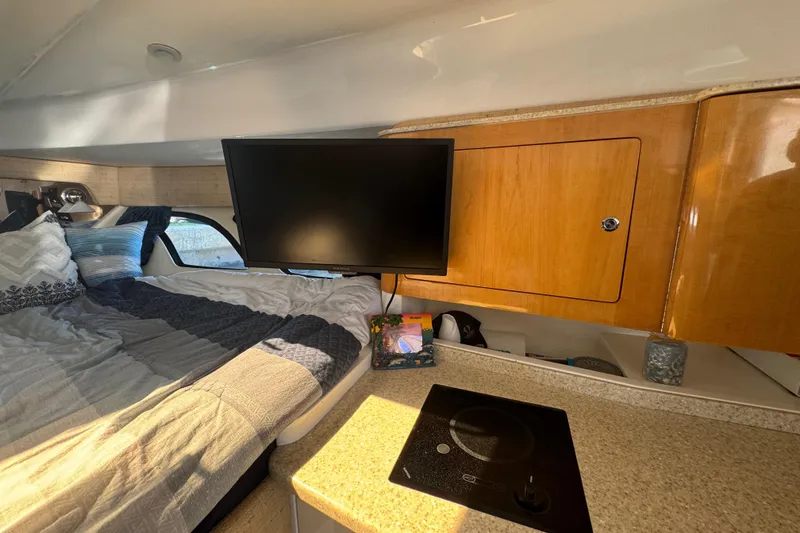 Slide: The Image of Interior of 2012 Intrepid 390 Sport Yacht with bed, TV, and kitchenette. - 68