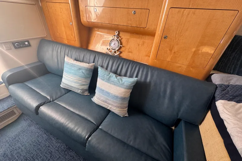 Slide: The Image of Luxurious interior of 2012 Intrepid 390 Sport Yacht with blue leather sofa and striped cushions. - 78