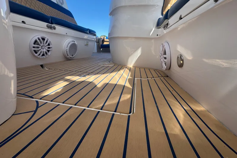 Slide: The Image of 2012 Intrepid 390 Sport Yacht deck with speakers and cushioned seating. - 82