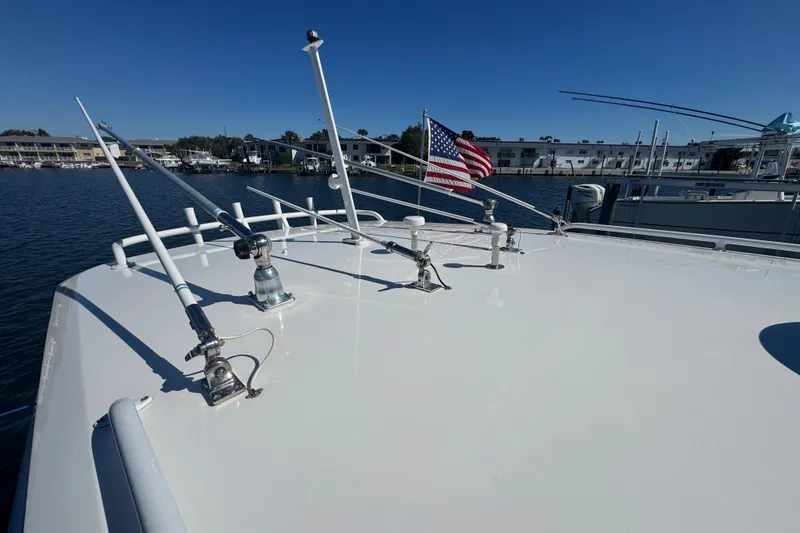 Slide: The Image of 2012 Intrepid 390 Sport Yacht deck with antennas and American flag, docked in marina. - 84