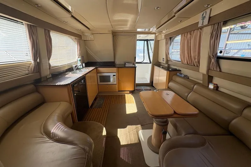 Slide: The Image of Interior of 2001 Bayliner 3488 Command Bridge Motoryacht with kitchen and seating area. - 13