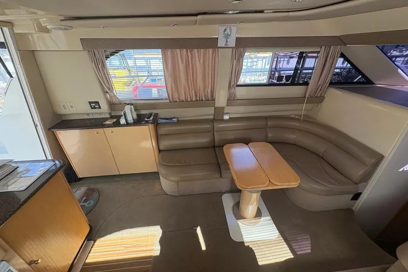 Slide: The Image of Interior of 2001 Bayliner 3488 Command Bridge Motoryacht with leather seating and wooden table. - 14