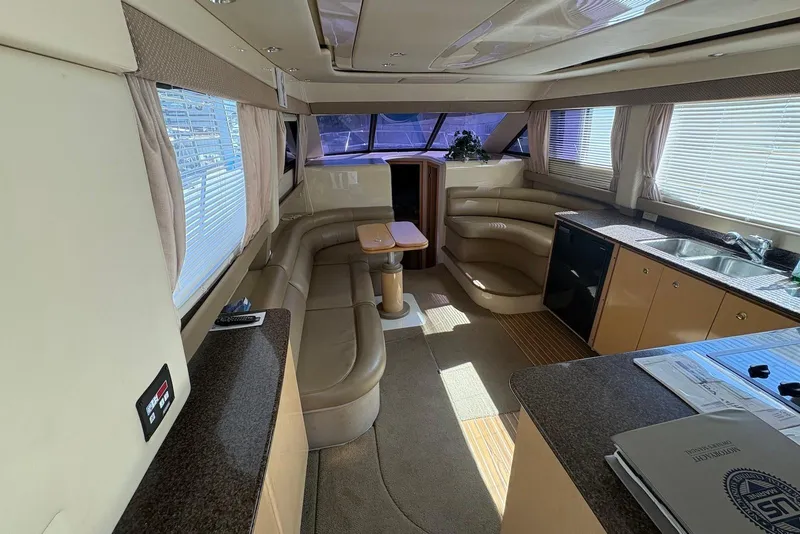 Slide: The Image of Luxurious interior of 2001 Bayliner 3488 Command Bridge Motoryacht with leather seating and kitchenette. - 15