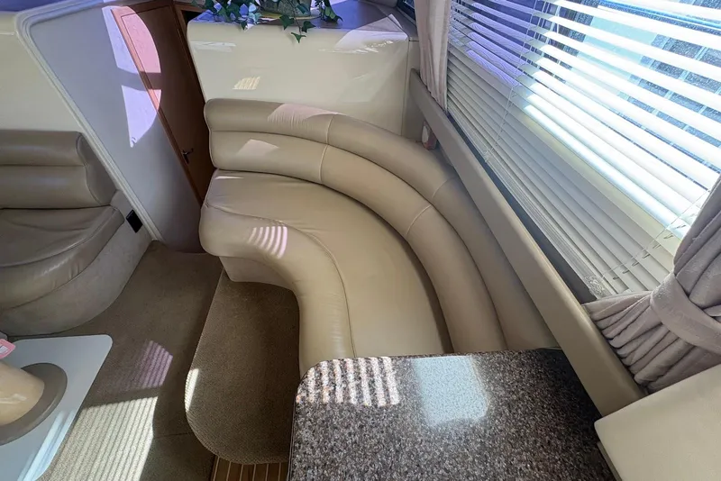 Slide: The Image of Interior of 2001 Bayliner 3488 Command Bridge Motoryacht with curved seating and window blinds. - 16