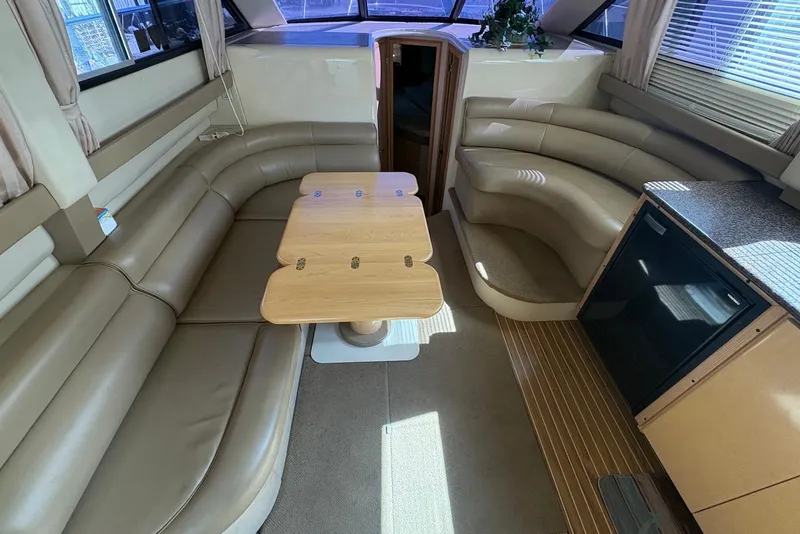 Slide: The Image of 2001 Bayliner 3488 Command Bridge Motoryacht interior with leather seating and wooden table. - 17